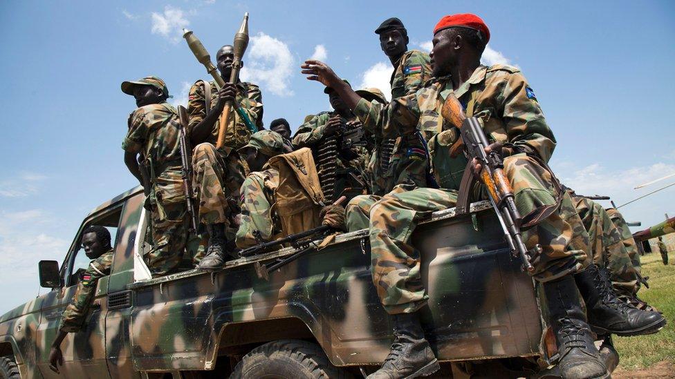 Soldiers of the Sudan People Liberation Army (SPLA) sit in a pick-up truck at the military base in Malakal, northern South Sudan, on October 16, 2016.