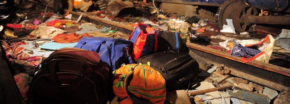 Rescue workers search for survivors in the wreckage of a derailed train near Pukhrayan in Kanpur district on November 20, 2016