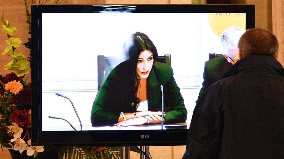 Man watches finance committee - chaired by Emma Little-Pengelly - on TV screen at Stormont, 23 August 2016