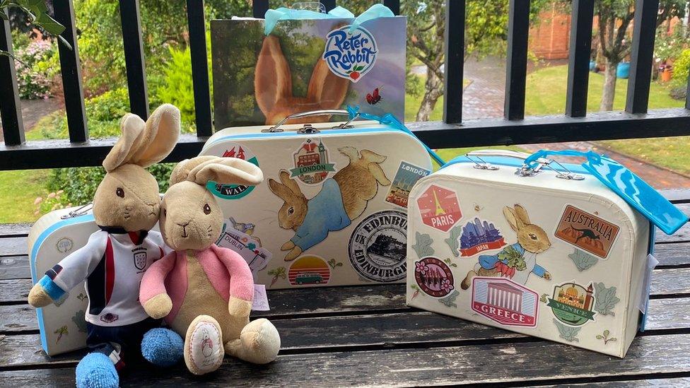 Peter Rabbit, his girlfriend, and luggage arrive on the doorstep