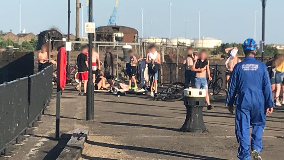 Picture of coastguard and young people by dock