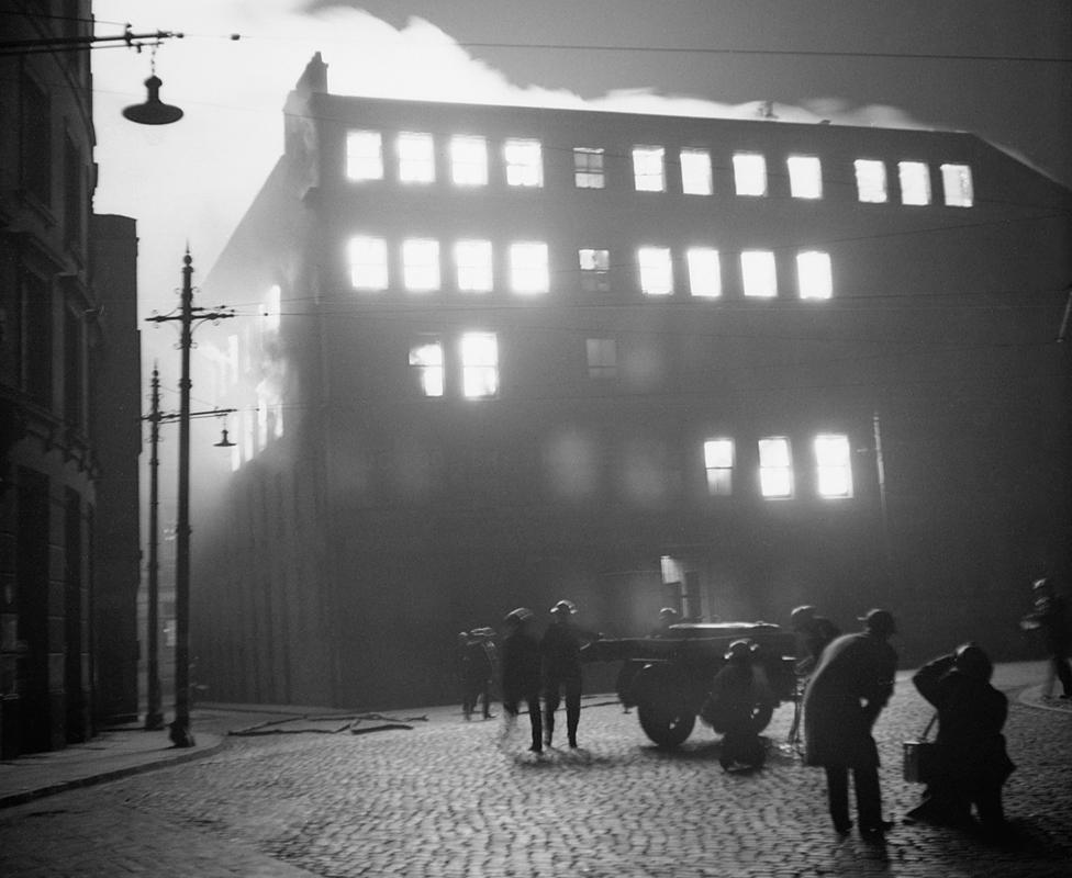 Burning building in Manchester after a German air raid, December 1940