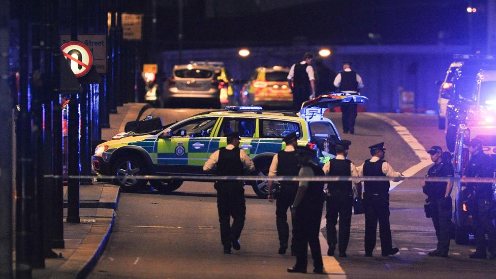 Police officers walk at the scene of an apparent terror attack on London Bridge in central London on June 3, 2017.