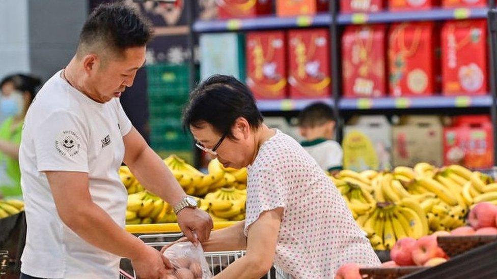 Customers shop at a supermarket in Qingzhou, East China's Shandong province, 10 July, 2023.