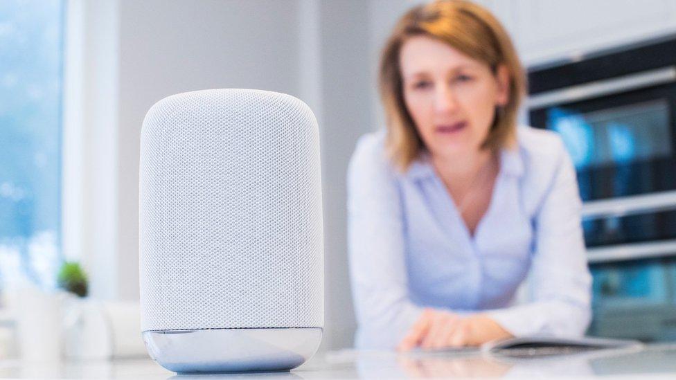 A woman uses her voice command device