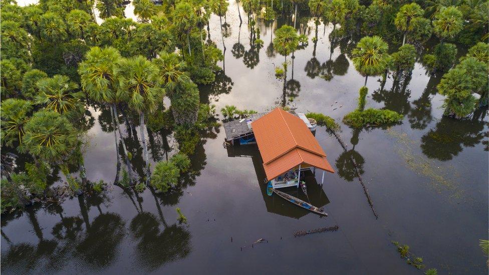 House in Thailand surrounded by flood waters