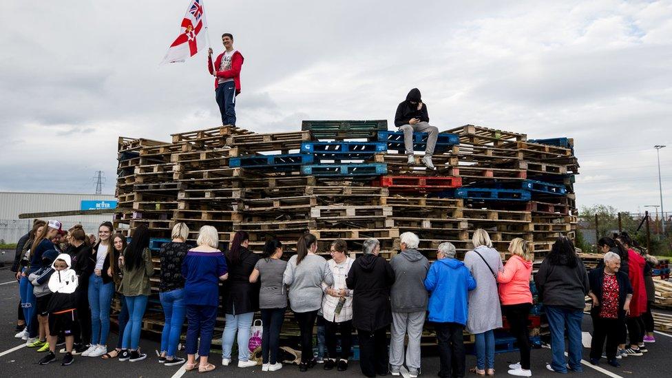 Woman surround the loyalist bonfire at Avoniel Leisure Centre