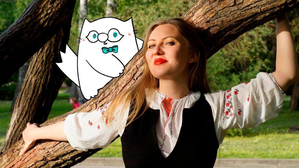 Ms Pavlova and her cartoon cat perching on a tree