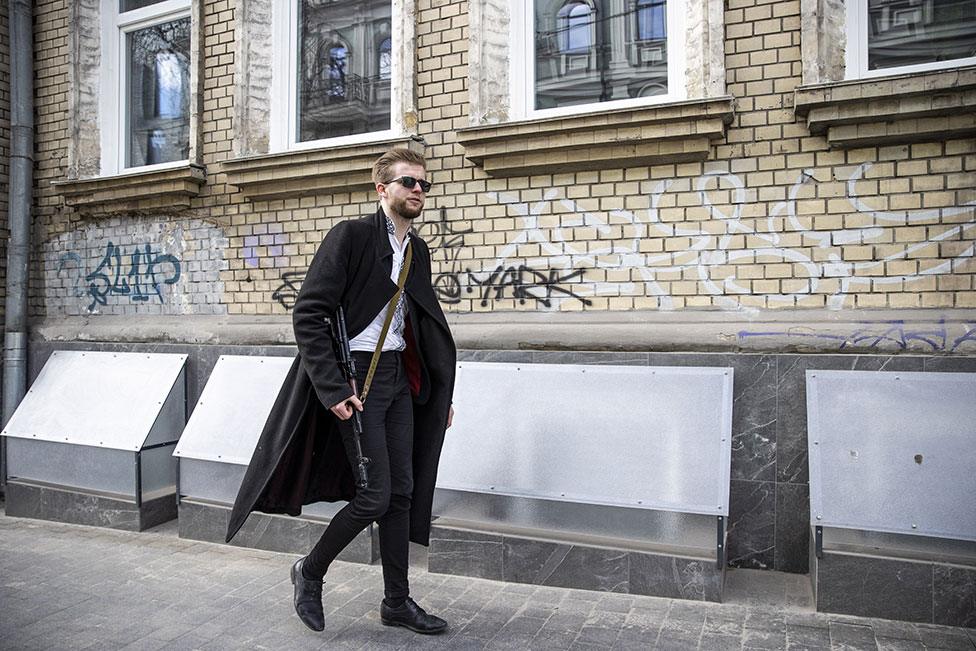 Ukrainian parliament member Sviatoslav Yurash, 26, is seen at a street with his weapon to defend Kyiv on 27 February 2022