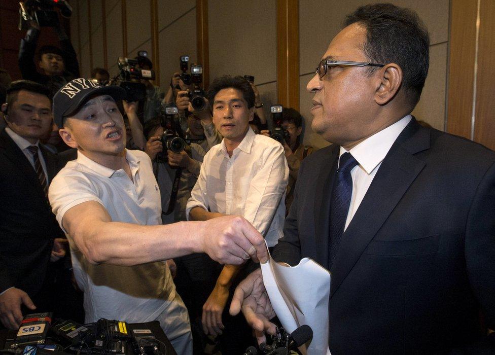 A relative of a victim complains to Ataur Safdar, head of British firm Reckitt Benckiser Korea, right, during a press conference in Seoul, South Korea, Monday, 2 May 2016