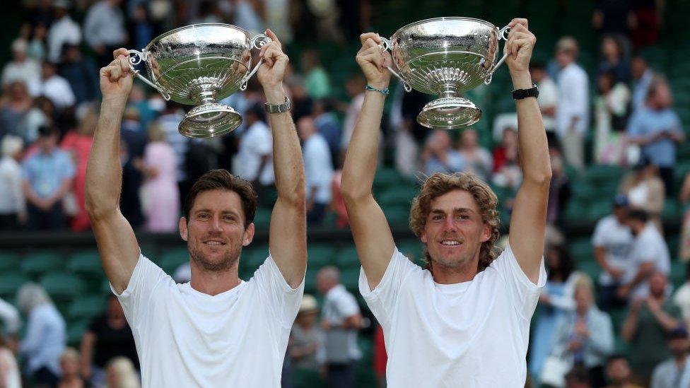 men's doubles finalists Matthew Ebden of Australia and partner Max Purcell of Australia celebrate their win holding their trophies above their heads