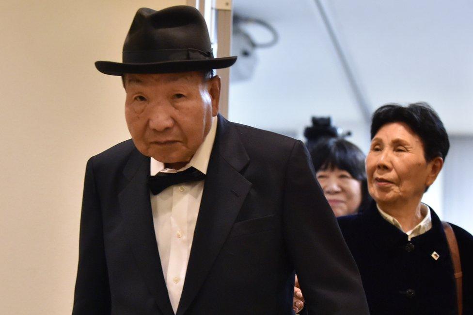 Former Japanese professional boxer Iwao Hakamada (L), who was sentenced to death for the murder of four members of a family in 1966 and released in 2014, and his sister Hideko (R) leave after a press conference in Tokyo on November 25, 2019.