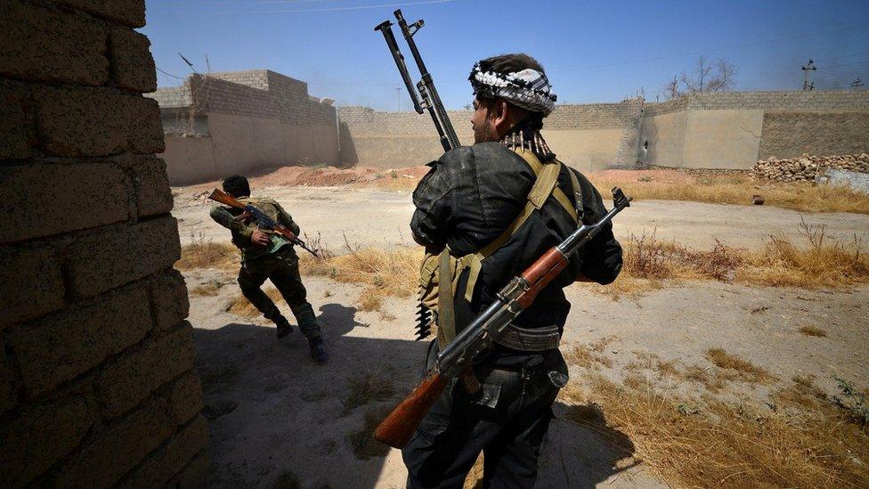 Members of the paramilitary Popular Mobilisation battle Islamic State militants inside Tal Afar, northern Iraq (23 August 2017)