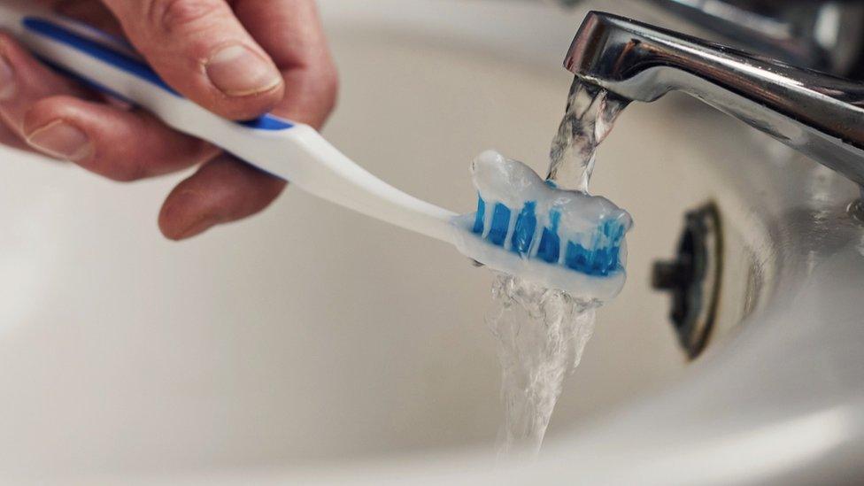 Toothbrush being rinsed