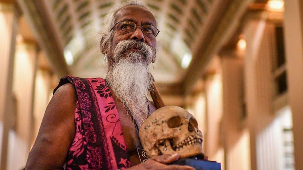 Vedda chief Wanniya Uruwarige with skull