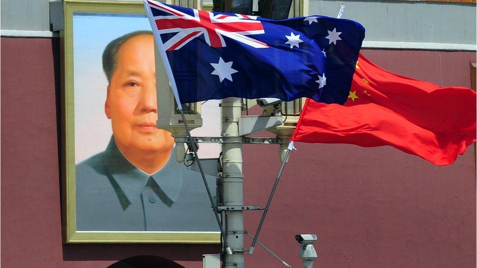 An Australian flag flying next to a Chinese flag in Tiananmen Square