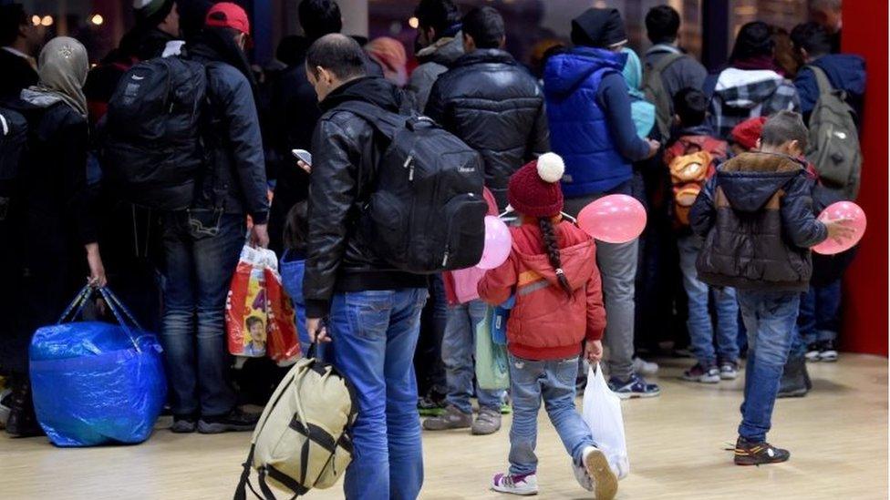 Migrants wait to board a ferry to Sweden in Kiel, Germany, on 2 November 2015.