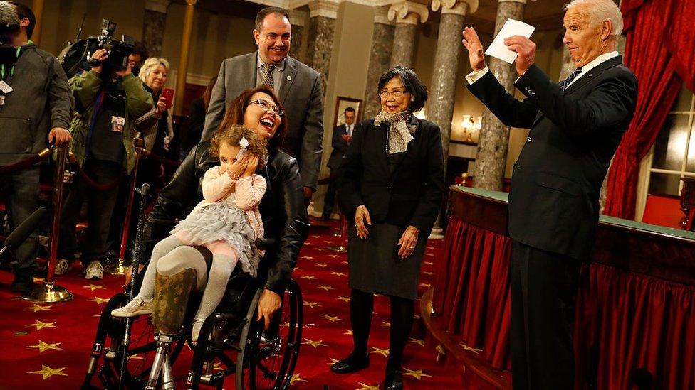 US Sen Tammy Duckworth participates in a re-enacted swearing-in with Joe Biden in January 2017