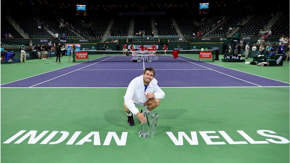 cameron smiling with his trophy at the indian wells competition in 2021