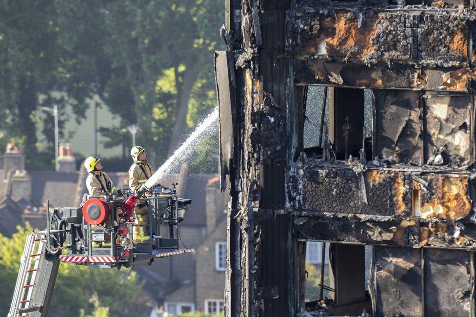 Firefighters spraying water on Grenfell Tower