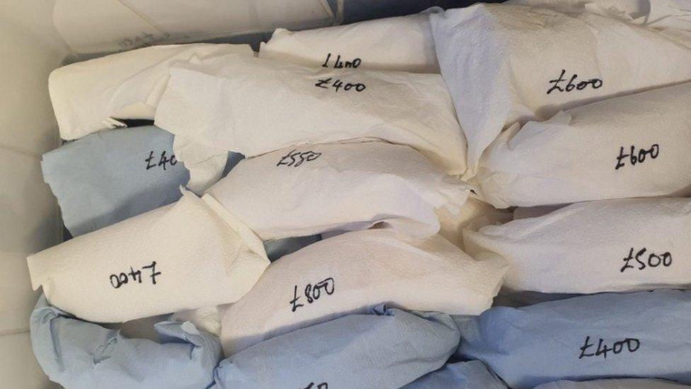 The packaged sperm whale teeth with prices written on