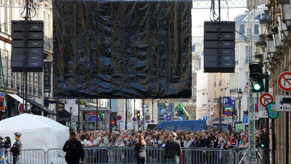 Crowds watch funeral on screen