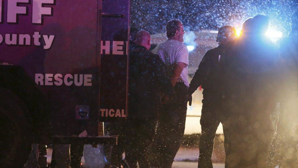 Suspect is taken into custody outside a Planned Parenthood centre in Colorado Springs, Colorado November 27, 2015