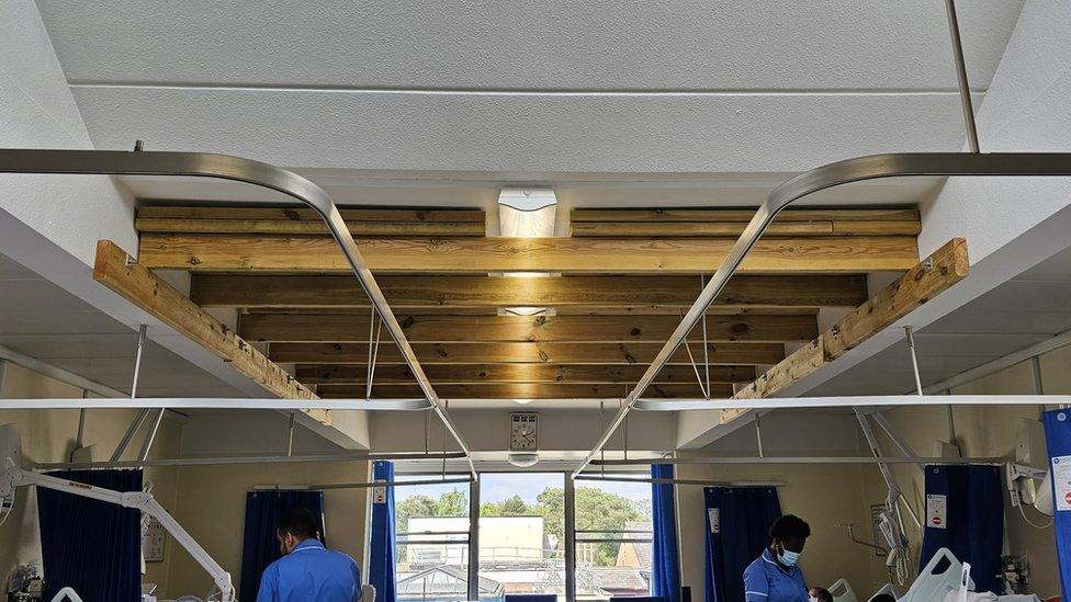 A hospital ward, with wooden props in the ceiling