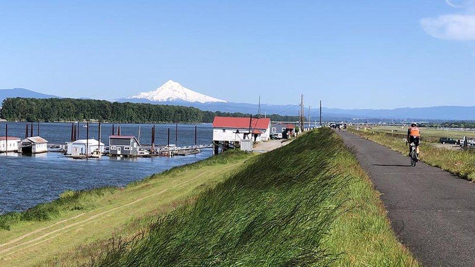 Cyclist on a path next to a body of water