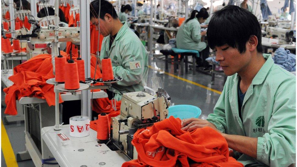 Workers sew in a clothing factory in Bozhou in east China's Anhui province