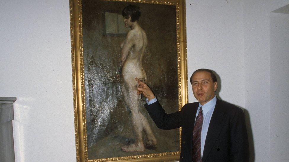 Silvio Berlusconi is seen with a painting