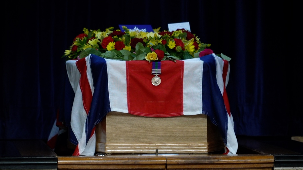 Ron Knight's coffin, draped with the Union Jack flag and medal