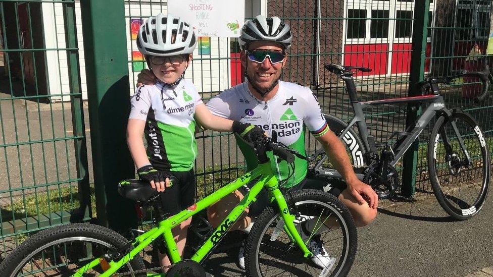 Boy standing next to Mark Cavendish