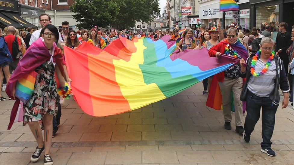 Pride flag carried through he centre of Norwich