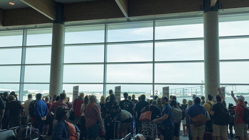 Passengers crowded to watch the plane arrive