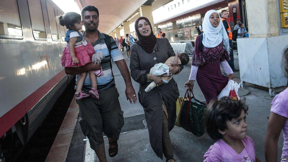 Migrants walk to their German connection in Vienna