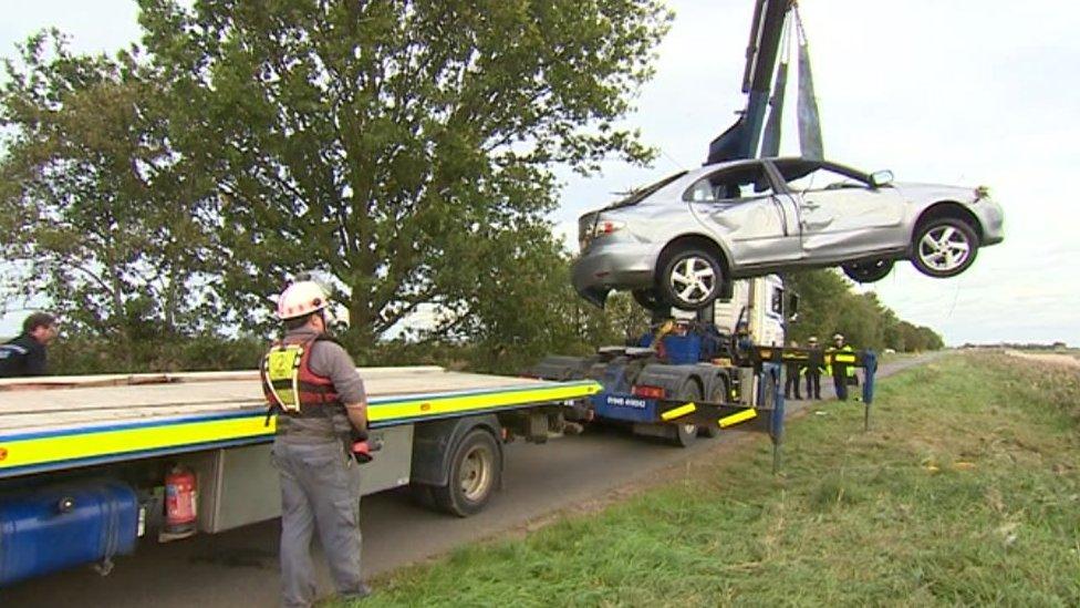 Car being winched out of ditch