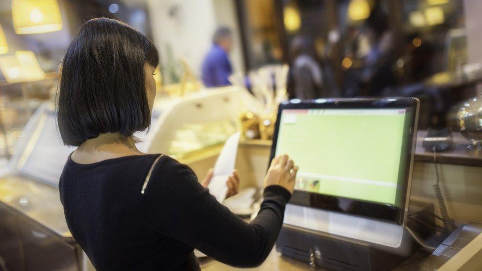 A woman using a till