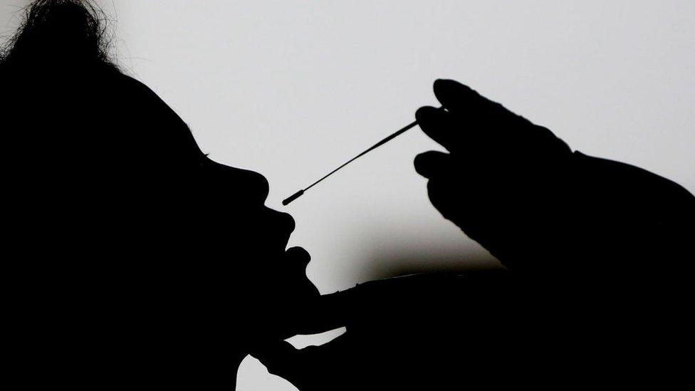 A medical staff take a swab sample of a government personnel to test for COVID-19 coronavirus at a quarantine facility in Hlaing University in Yangon in preparation the 73rd anniversary of Martyrs' Day ceremony on July 16, 2020.