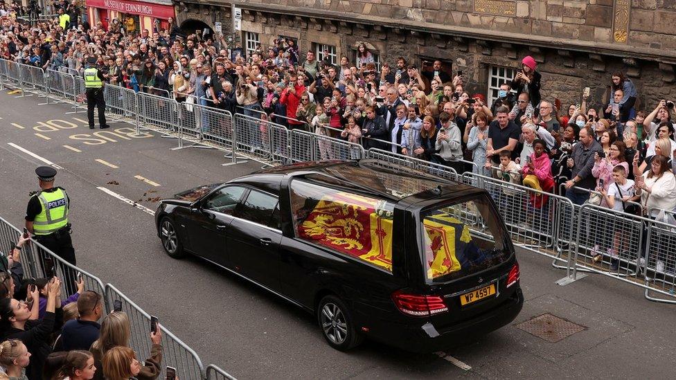 The coffin is driven down the Royal Mile in Edinburgh