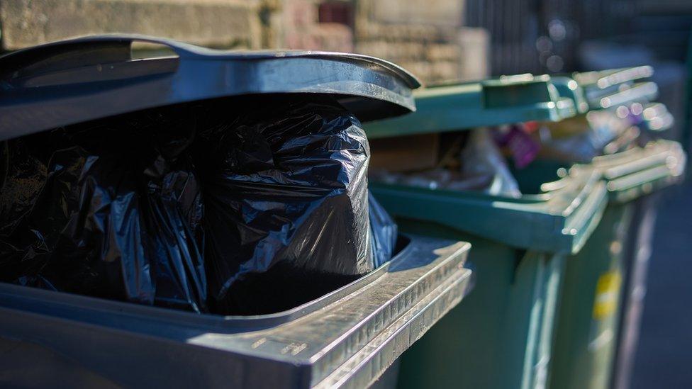 Overflowing wheelie bins