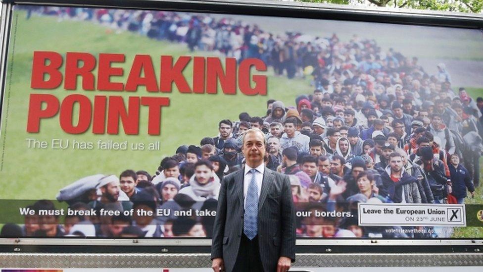 Nigel Farage stands in front of UKIP's "Breaking Point" poster