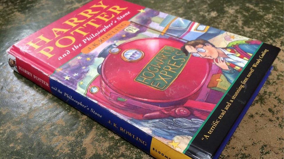 A-Harry-Potter-first-edition-lays-on-a-table.