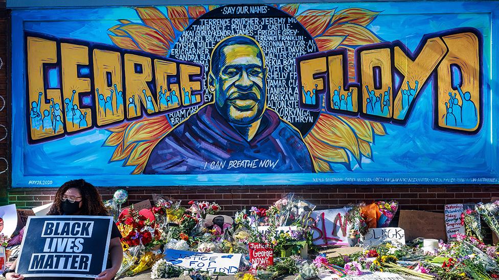 Flowers, signs and balloons are left near a makeshift memorial to George Floyd near the spot where he died while in custody of the Minneapolis police, on May 29, 2020 in Minneapolis, Minnesota