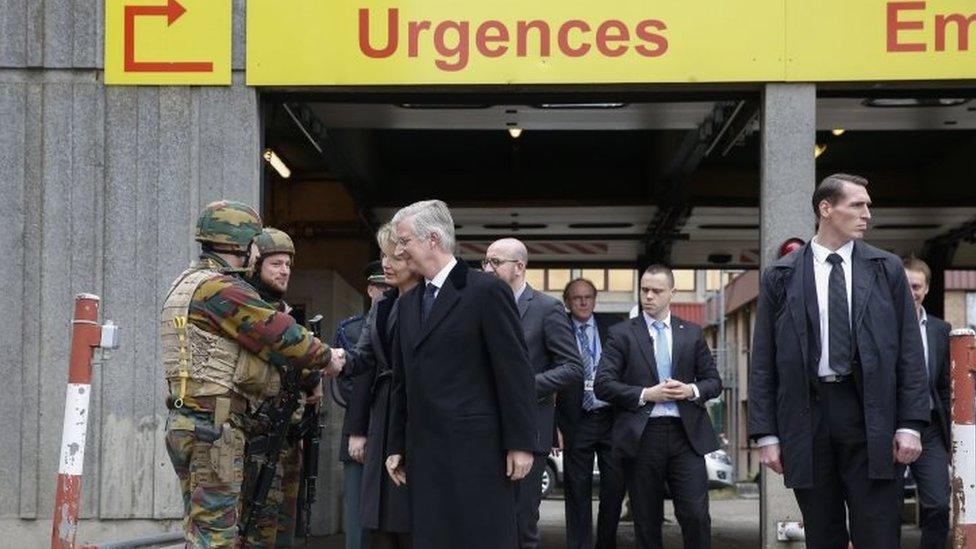 King Philippe of Belgium (centre) and Queen Mathilde greet security services members. Photo: 23 March 2016