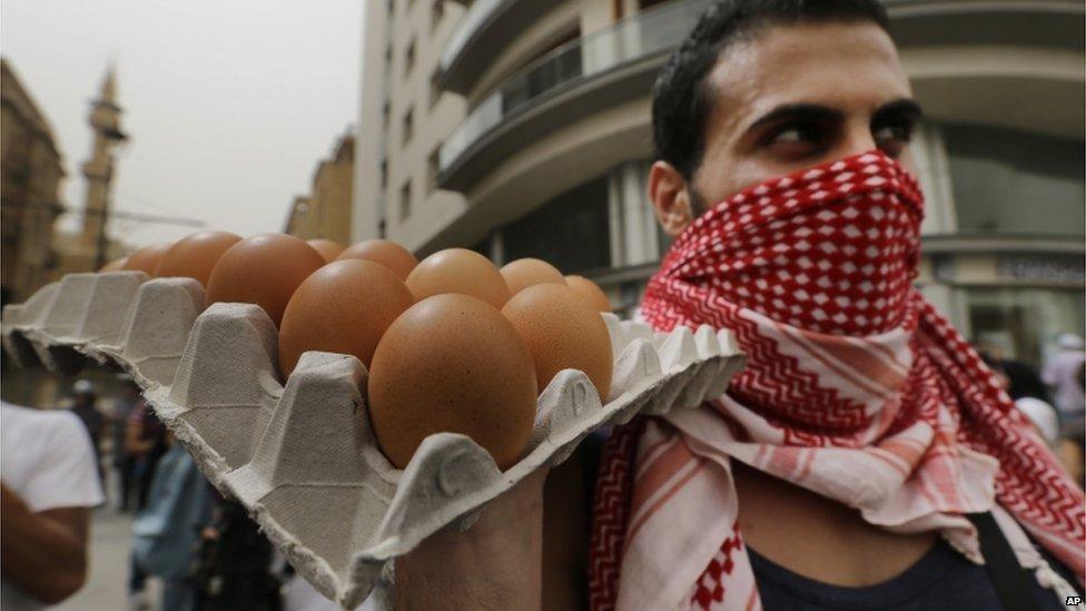 A Lebanese anti-government protester holds eggs in downtown Beirut, Lebanon, on 9 September 2015