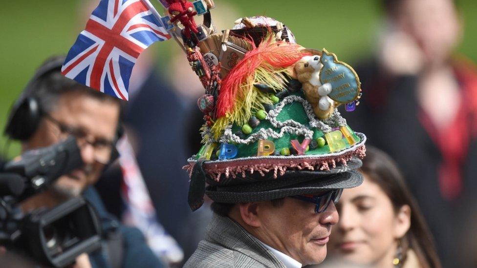 A man with a colourful hat among the crowds in Windsor