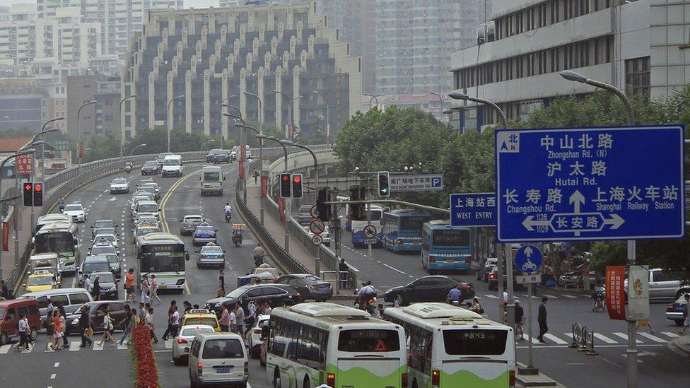 A major street in Shanghai with road signs in both Chinese and English