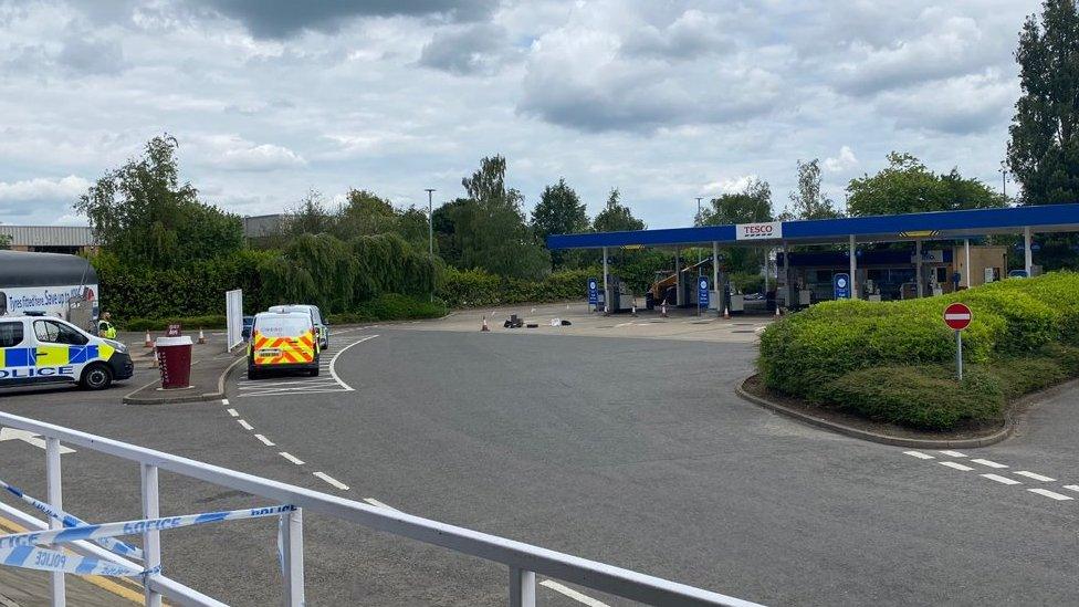 Police vehicles at scene of ram-raid at Tesco petrol station