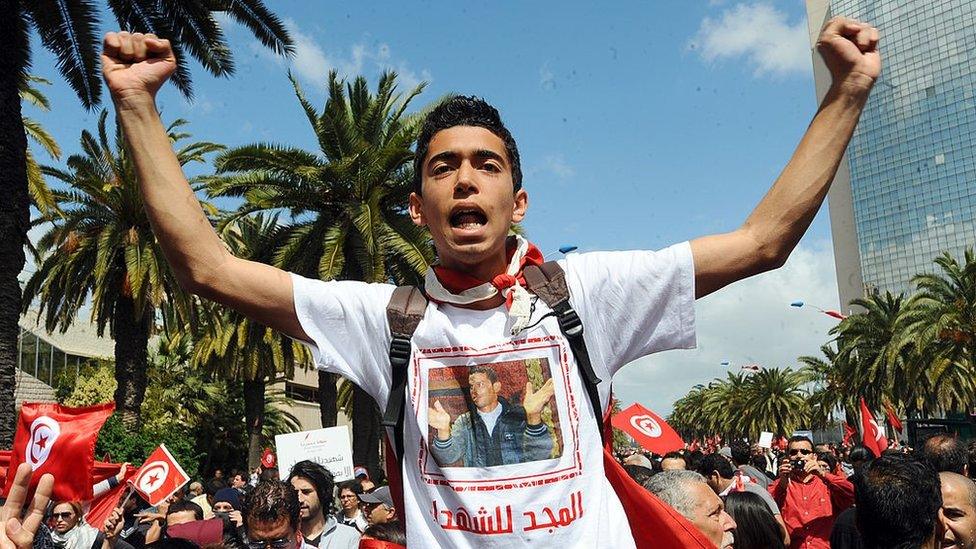 A man wearing a tee-shirt with a portrait of Tunisian protest hero Mohamed Bouazizi shouts during a demonstration on April 9, 2012 in Tunis